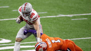 NEW ORLEANS, LOUISIANA - JANUARY 01: Jeremy Ruckert #88 of the Ohio State Buckeyes stiff arms Derion Kendrick #1 of the Clemson Tigers in the first half during the College Football Playoff semifinal game at the Allstate Sugar Bowl at Mercedes-Benz Superdome on January 01, 2021 in New Orleans, Louisiana. (Photo by Sean Gardner/Getty Images)
