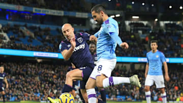 Manchester City's German midfielder Ilkay Gundogan vies with West Ham United's Argentinian defender Pablo Zabaleta (L) during the English Premier League football match between Manchester City and West Ham United at the Etihad Stadium in Manchester, north west England, on February 19, 2020. (Photo by Lindsey Parnaby / AFP) / RESTRICTED TO EDITORIAL USE. No use with unauthorized audio, video, data, fixture lists, club/league logos or 'live' services. Online in-match use limited to 120 images. An additional 40 images may be used in extra time. No video emulation. Social media in-match use limited to 120 images. An additional 40 images may be used in extra time. No use in betting publications, games or single club/league/player publications. / (Photo by LINDSEY PARNABY/AFP via Getty Images)