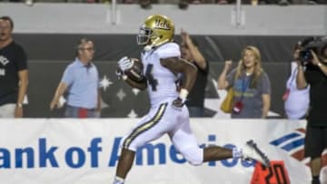 Sep 12, 2015; Las Vegas, NV, USA; UCLA Bruins running back Paul Perkins (24) runs the ball in for a touchdown against the UNLV Rebels during the third quarter at Sam Boyd Stadium. Mandatory Credit: Joshua Dahl-USA TODAY Sports