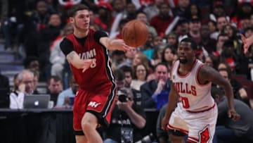 Jan 25, 2016; Chicago, IL, USA; Miami Heat guard Tyler Johnson (8) passes around Chicago Bulls guard Aaron Brooks (0) during the second quarter at the United Center. Mandatory Credit: Dennis Wierzbicki-USA TODAY Sports