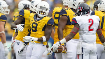 Sep 12, 2015; Morgantown, WV, USA; Liberty Flames running back D.J. Abnar (2) and West Virginia Mountaineers safety Karl Joseph exchange words after a play during the second quarter at Milan Puskar Stadium. Mandatory Credit: Ben Queen-USA TODAY Sports