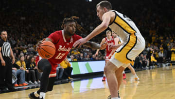 Nebraska basketball guard Denim Dawson (12) is defended by Iowa Hawkeyes forward Payton Sandfort (20) during the first half at Carver-Hawkeye Arena. (Jeffrey Becker-USA TODAY Sports)