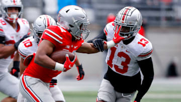 Apr 17, 2021; Columbus, Ohio, USA; Ohio State Buckeyes running back TreVeyon Henderson (34) stiff arms cornerback Tyreke Johnson (13) during the second quarter of the annual spring game at Ohio Stadium. Mandatory Credit: Joseph Maiorana-USA TODAY Sports