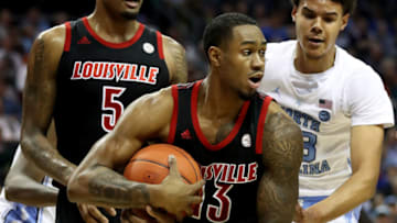CHARLOTTE, NORTH CAROLINA - MARCH 14: V.J. King #13 of the Louisville Cardinals battles for possession against Cameron Johnson #13 of the North Carolina Tar Heels during their game in the quarterfinal round of the 2019 Men's ACC Basketball Tournament at Spectrum Center on March 14, 2019 in Charlotte, North Carolina. (Photo by Streeter Lecka/Getty Images)