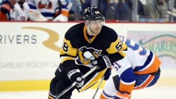 Jan 2, 2016; Pittsburgh, PA, USA; Pittsburgh Penguins defenseman Kris Letang (58) handles the puck against New York Islanders center Frans Nielsen (51) during the third period at the CONSOL Energy Center. The Penguins won 5-2. Mandatory Credit: Charles LeClaire-USA TODAY Sports