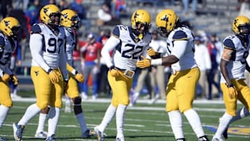 Nov 21, 2015; Lawrence, KS, USA; West Virginia Mountaineers safety Jarrod Harper (22) is congratulated by defensive lineman Christian Brown (95) after recovering a fumble against the Kansas Jayhawks in the first half at Memorial Stadium. Mandatory Credit: John Rieger-USA TODAY Sports