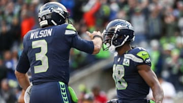 SEATTLE, WA - DECEMBER 02: Jaron Brown #18 of the Seattle Seahawks celebrates a touchdown with Russell Wilson #3 in the third quarter against the San Francisco 49ers at CenturyLink Field on December 2, 2018 in Seattle, Washington. (Photo by Abbie Parr/Getty Images)