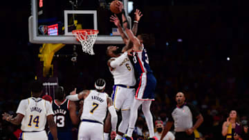 Dec 25, 2021; Los Angeles, California, USA; Brooklyn Nets forward Nic Claxton (33) dunks over Los Angeles Lakers forward LeBron James (6) during the second half at Crypto.com Arena. Mandatory Credit: Gary A. Vasquez-USA TODAY Sports