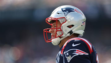 FOXBOROUGH, MASSACHUSETTS - SEPTEMBER 26: Quarterback Mac Jones #10 of the New England Patriots looks on during the first quarter of the game against the New Orleans Saints at Gillette Stadium on September 26, 2021 in Foxborough, Massachusetts. (Photo by Elsa/Getty Images)