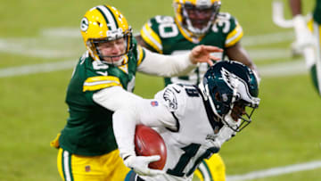 Dec 6, 2020; Green Bay, Wisconsin, USA; Philadelphia Eagles wide receiver Jalen Reagor (18) returns a punt for a touchdown as Green Bay Packers punter JK Scott (6) chases from behind during the fourth quarter at Lambeau Field. Mandatory Credit: Jeff Hanisch-USA TODAY Sports