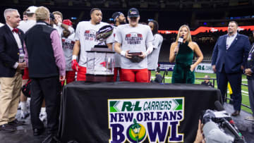 Dec 21, 2022; New Orleans, Louisiana, USA; Western Kentucky Hilltoppers quarterback Austin Reed (16) poses with the MVP trophy after defeating the South Alabama Jaguars at Caesars Superdome. Mandatory Credit: Stephen Lew-USA TODAY Sports
