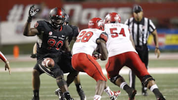 Sep 19, 2015; Fresno, CA, USA; Utah Utes running back Joe Williams (28) fumbles a handoff exchange which would be recovered by Fresno State Bulldogs defensive end Claudell Louis (90) in the fourth quarter at Bulldog Stadium. The Utes defeated the Bulldogs 45-24. Mandatory Credit: Cary Edmondson-USA TODAY Sports