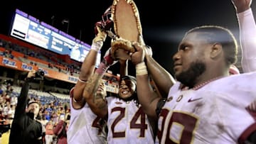 Nov 28, 2015; Gainesville, FL, USA; Florida State Seminoles linebacker Terrance Smith (24) and defensive tackle Nile Lawrence-Stample (99) and react after beating the Florida Gators at Ben Hill Griffin Stadium. Florida State defeated Florida 27-2. Mandatory Credit: Kim Klement-USA TODAY Sports
