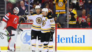 NEWARK, NJ - NOVEMBER 19: Boston Bruins right wing David Pastrnak (88) celebrates with teammate Boston Bruins center Brad Marchand (63) after scoring during the National Hockey League game between the New Jersey Devils and the Boston Bruins on November 19, 2019 at the Prudential Center in Newark, NJ. (Photo by Rich Graessle/Icon Sportswire via Getty Images)