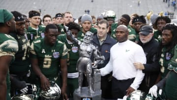 BIRMINGHAM, AL - DECEMBER 23: Head coach Charlie Strong of the South Florida Bulls gathers his team around the championship trophy following the Birmingham Bowl against the Texas Tech Red Raiders at Legion Field on December 23, 2017 in Birmingham, Alabama. South Florida won 38-34. (Photo by Joe Robbins/Getty Images)