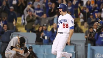 LOS ANGELES, CA - MAY 09: Ross Stripling #68 of the Los Angeles Dodgers reacts after scoring the game-winning run in the tenth inning as pitcher Daniel Hudson #41 of the Pittsburgh Pirates hangs his head after the MLB game at Dodger Stadium on May 9, 2017 in Los Angeles, California. (Photo by Victor Decolongon/Getty Images)
