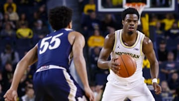 Nov 26, 2016; Ann Arbor, MI, USA; Michigan Wolverines guard Derrick Walton Jr. (10) moves the ball defended by Mount St. Mary's Mountaineers guard Elijah Long (55) in the first half at Crisler Center. Mandatory Credit: Rick Osentoski-USA TODAY Sports