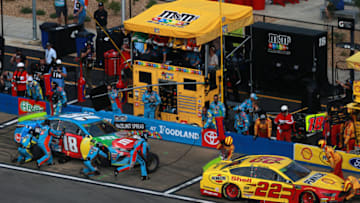 TALLADEGA, ALABAMA - OCTOBER 14: Kyle Busch, driver of the #18 M&M's Hazelnut Toyota, and Joey Logano, driver of the #22 Shell Pennzoil Ford, pit during the Monster Energy NASCAR Cup Series 1000Bulbs.com 500 at Talladega Superspeedway on October 14, 2019 in Talladega, Alabama. (Photo by Sean Gardner/Getty Images)
