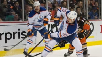 Dec 10, 2014; Anaheim, CA, USA; Edmonton Oilers center Matt Hendricks (23) and Anaheim Ducks center Ryan Kesler (17) battle for possession of the puck during the third period at Honda Center. Mandatory Credit: Robert Hanashiro-USA TODAY Sports