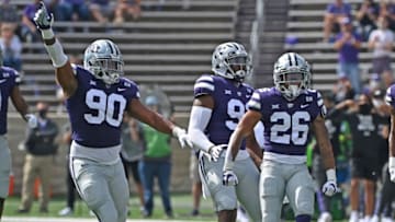 MANHATTAN, KS - SEPTEMBER 12: Defensive back Will Jones II #26 of the Kansas State Wildcats and defensive end Bronson Massie #90 reacts after a intercepting against the Arkansas State Red Wolves, during the first half at Bill Snyder Family Football Stadium on September 12, 2020 in Manhattan, Kansas. (Photo by Peter G. Aiken/Getty Images)