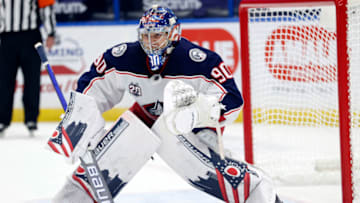 Apr 1, 2021; Tampa, Florida, USA; Columbus Blue Jackets goaltender Elvis Merzlikins (90) defends during the first period against the Tampa Bay Lightning at Amalie Arena. Mandatory Credit: Kim Klement-USA TODAY Sports