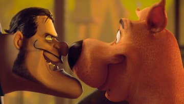 (L-r) Dick Dastardly voiced by JASON ISAACS and Scooby-Doo voiced by FRANK WELKER in the new animated adventure “SCOOB!” from Warner Bros. Pictures and Warner Animation Group. Courtesy of Warner Bros. Pictures