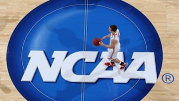 Mar 24, 2013; Dayton, OH, USA; Ohio State Buckeyes guard Aaron Craft (4) brings the ball up court across the NCAA logo in a game against the Iowa State Cyclones during the third round of the 2013 NCAA tournament at University of Dayton Arena. Ohio State defeats Iowa State 78-75. Mandatory Credit: Brian Spurlock-USA TODAY Sports