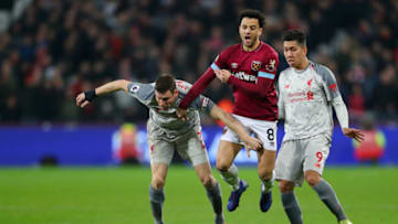 LONDON, ENGLAND - FEBRUARY 04: Felipe Anderson of West Ham United is tackled by James Milner of Liverpool and Roberto Firmino of Liverpool during the Premier League match between West Ham United and Liverpool FC at London Stadium on February 04, 2019 in London, United Kingdom. (Photo by Catherine Ivill/Getty Images)
