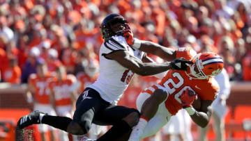 CLEMSON, SC - NOVEMBER 03: P.J. Blue #13 of the Louisville Cardinals tackles Tavien Feaster #28 of the Clemson Tigers during their game at Clemson Memorial Stadium on November 3, 2018 in Clemson, South Carolina. (Photo by Streeter Lecka/Getty Images)