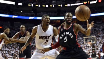 May 9, 2016; Miami, FL, USA; Toronto Raptors forward DeMarre Carroll (5) gains control of a loose ball in front of Miami Heat forward Joe Johnson (2) during the second quarter in game four of the second round of the NBA Playoffs at American Airlines Arena. Mandatory Credit: Steve Mitchell-USA TODAY Sports