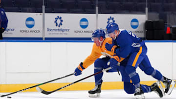 BUFFALO, NY - JANUARY 1: Brett Murray #57 skates with the puck as Rasmus Asplund #74 of the Buffalo Sabres defends during training camp at KeyBank Center on January 1, 2021 in Buffalo, New York. (Photo by Kevin Hoffman/Getty Images)