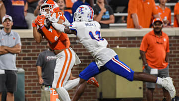 Sep 17, 2022; Clemson, South Carolina, USA; Clemson Tigers wide receiver Antonio Williams(0) scores against Louisiana Tech Bulldogs defensive back Myles Brooks (13) during the fourth quarter at Memorial Stadium. Mandatory Credit: Ken Ruinard-USA TODAY Sports