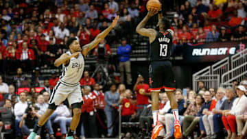 HOUSTON, TX - MARCH 22: James Harden #13 of the Houston Rockets takes a three point shot defended by Rudy Gay #22 of the San Antonio Spurs in the fourth quarter at Toyota Center on March 22, 2019 in Houston, Texas. NOTE TO USER: User expressly acknowledges and agrees that, by downloading and or using this photograph, User is consenting to the terms and conditions of the Getty Images License Agreement. (Photo by Tim Warner/Getty Images)