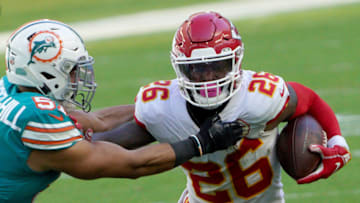MIAMI GARDENS, FLORIDA - DECEMBER 13: Le'Veon Bell #26 of the Kansas City Chiefs carries the ball against Kamu Grugier-Hill #51 of the Miami Dolphins during the first half of the game at Hard Rock Stadium on December 13, 2020 in Miami Gardens, Florida. (Photo by Mark Brown/Getty Images)