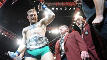 December 12, 2015; Las Vegas, NV, USA; Conor McGregor exits the octagon following his championship victory against Jose Aldo during UFC 194 at MGM Grand Garden Arena. Mandatory Credit: Gary A. Vasquez-USA TODAY Sports