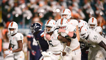 MIAMI, FLORIDA - OCTOBER 11: N'Kosi Perry #5 of the Miami Hurricanes celebrates a touchdown with teammates against the Virginia Cavaliers in the second half at Hard Rock Stadium on October 11, 2019 in Miami, Florida. (Photo by Mark Brown/Getty Images)