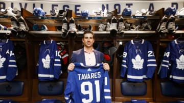 TORONTO, ON - JULY 1: John Tavares #91 of the Toronto Maple Leafs, poses with his jersey in the dressing room, after he signed with the Toronto Maple Leafs, at the Scotiabank Arena on July 1, 2018 in Toronto, Ontario, Canada. (Photo by Mark Blinch/NHLI via Getty Images)