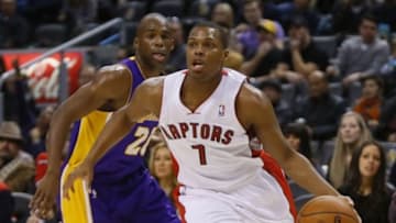 Jan 19, 2014; Toronto, Ontario, CAN; Toronto Raptors guard Kyle Lowry (7) carries the ball past Los Angeles Lakers guard Jodie Meeks (20) during the first half at the Air Canada Centre. Mandatory Credit: John E. Sokolowski-USA TODAY Sports