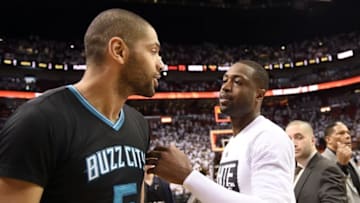 May 1, 2016; Miami, FL, USA; Miami Heat guard Dwyane Wade (right) greets Charlotte Hornets guard Nicolas Batum (left) after game seven of the first round of the NBA Playoffs at American Airlines Arena. The Heat won 106-73. Mandatory Credit: Steve Mitchell-USA TODAY Sports
