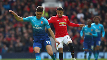 MANCHESTER, ENGLAND - APRIL 29: Konstantinos Mavropanos of Arsenal is challenged by Jesse Lingard of Manchester United during the Premier League match between Manchester United and Arsenal at Old Trafford on April 29, 2018 in Manchester, England. (Photo by Clive Brunskill/Getty Images)