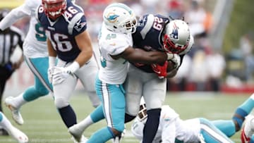 Sep 18, 2016; Foxborough, MA, USA; New England Patriots running back LeGarrette Blount (29) is tackled by Miami Dolphins outside linebacker Neville Hewitt (46) during the fourth quarter at Gillette Stadium. The New England Patriots won 31-24. Mandatory Credit: Greg M. Cooper-USA TODAY Sports