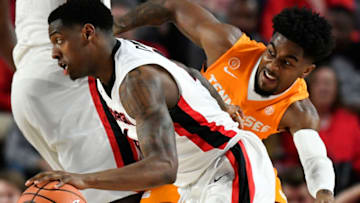 ATHENS, GA - FEBRUARY 17: Tyree Crump #4 of the Georgia basketball Bulldogs dribbles past Jordan Bone #0 of the Tennessee Volunteers during the basketball game at Stegeman Coliseum on February 17, 2018 in Athens, Georgia. (Photo by Mike Comer/Getty Images)