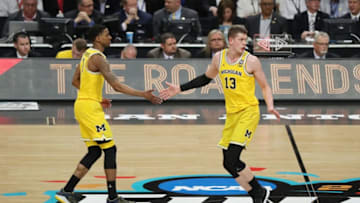 SAN ANTONIO, TX - MARCH 31: Moritz Wagner #13 and Charles Matthews #1 of the Michigan Wolverines react after a play in the first half against the Loyola Ramblers during the 2018 NCAA Men's Final Four Semifinal at the Alamodome on March 31, 2018 in San Antonio, Texas. (Photo by Chris Covatta/Getty Images)