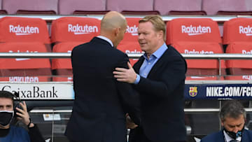 Barcelona's Dutch coach Ronald Koeman (R) congratulates Real Madrid's French coach Zinedine Zidane at the end of the Spanish League football match between Barcelona and Real Madrid at the Camp Nou stadium in Barcelona on October 24, 2020. (Photo by LLUIS GENE / AFP) (Photo by LLUIS GENE/AFP via Getty Images)