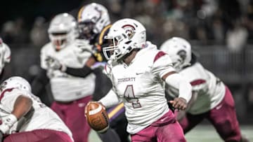 Dougherty’s quarterback Kameron Davis scrambles in the pocket to avoid a sack from the Cavaliers’ defense.
