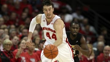 Nov 14, 2014; Madison, WI, USA; Wisconsin Badgers forward Frank Kaminsky (44) drives the ball up the floor as Northern Kentucky Norse guard Todd Johnson (right) follows at the Kohl Center. Wisconsin defeated Northern Kentucky 62-31. Mandatory Credit: Mary Langenfeld-USA TODAY Sports