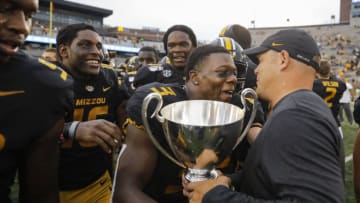 COLUMBIA, MO - SEPTEMBER 21: Ronnell Perkins #3 of the Missouri Tigers gives the Mayors Cup trophy to head coach Barry Odom of the Missouri Tigers following the 34-14 victory over the South Carolina Gamecocks at Faurot Field/Memorial Stadium on September 21, 2019 in Columbia, Missouri. Perkins had a 100-yard interception return for a touchdown in the game. (Photo by David Eulitt/Getty Images)