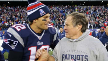 Dec 14, 2014; Foxborough, MA, USA; New England Patriots quarterback Tom Brady (12) celebrates with head coach Bill Belichick (R) after clinching the AFC East title with a 41-13 win over the Miami Dolphins at Gillette Stadium. Mandatory Credit: Winslow Townson-USA TODAY Sports