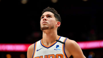 PORTLAND, OREGON - MARCH 10: Devin Booker #1 of the Phoenix Suns looks on during the first half of the game against the Portland Trail Blazers at the Moda Center on March 10, 2020 in Portland, Oregon. NOTE TO USER: User expressly acknowledges and agrees that, by downloading and or using this photograph, User is consenting to the terms and conditions of the Getty Images License Agreement. (Photo by Alika Jenner/Getty Images)