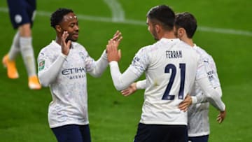 Manchester City's Spanish midfielder Ferran Torres (2nd R) celebrates with Manchester City's English midfielder Raheem Sterling (L) and Manchester City's Portuguese midfielder Bernardo Silva (R) after scoring their third goal during the English League Cup fourth round football match between Burnley and Manchester City at Turf Moor in Burnley, north west England on September 30, 2020. (Photo by Paul ELLIS / POOL / AFP) / RESTRICTED TO EDITORIAL USE. No use with unauthorized audio, video, data, fixture lists, club/league logos or 'live' services. Online in-match use limited to 120 images. An additional 40 images may be used in extra time. No video emulation. Social media in-match use limited to 120 images. An additional 40 images may be used in extra time. No use in betting publications, games or single club/league/player publications. / (Photo by PAUL ELLIS/POOL/AFP via Getty Images)